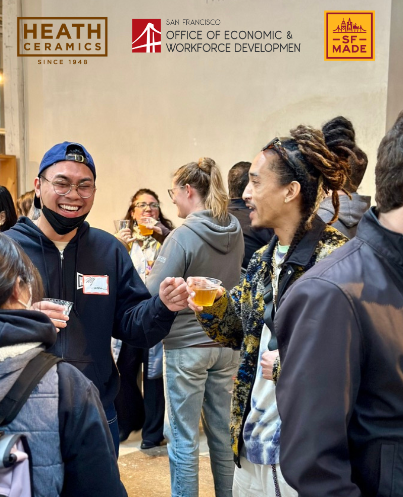 Group of people holding drinks talking and laughing